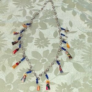 Nativity scene necklace and 25 inches in length.